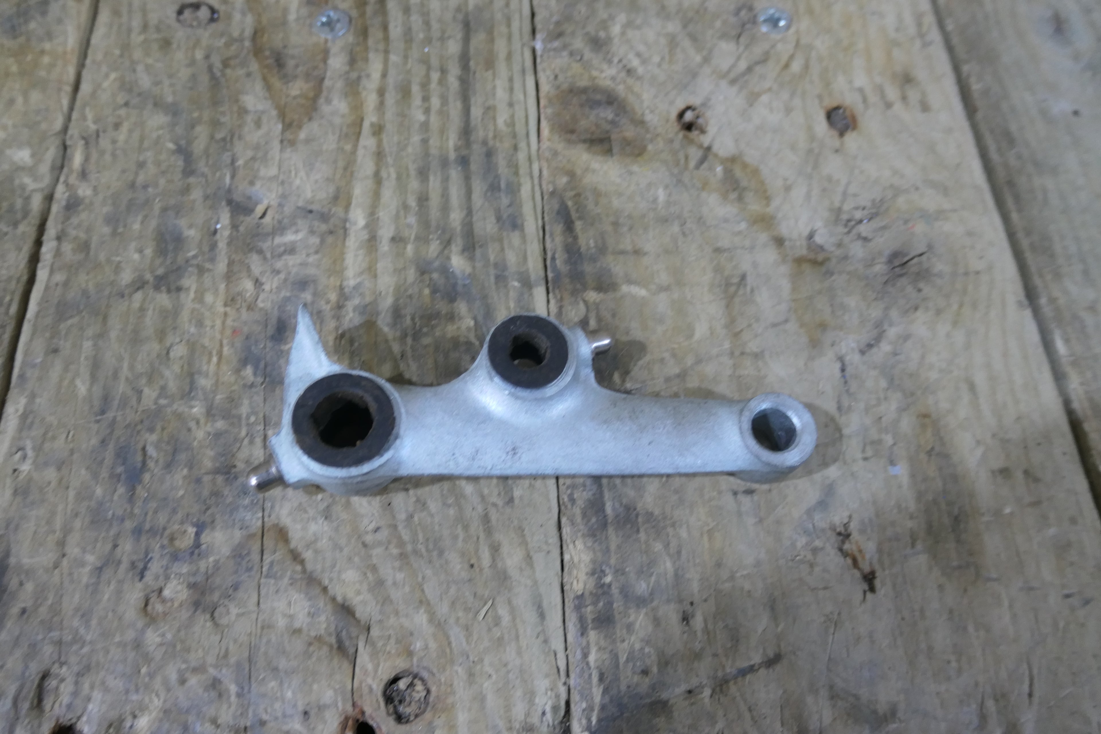 Honda P50 P25 ,Left Suspension Arm, Genuine NOS Honda Part Number 51220-044-040